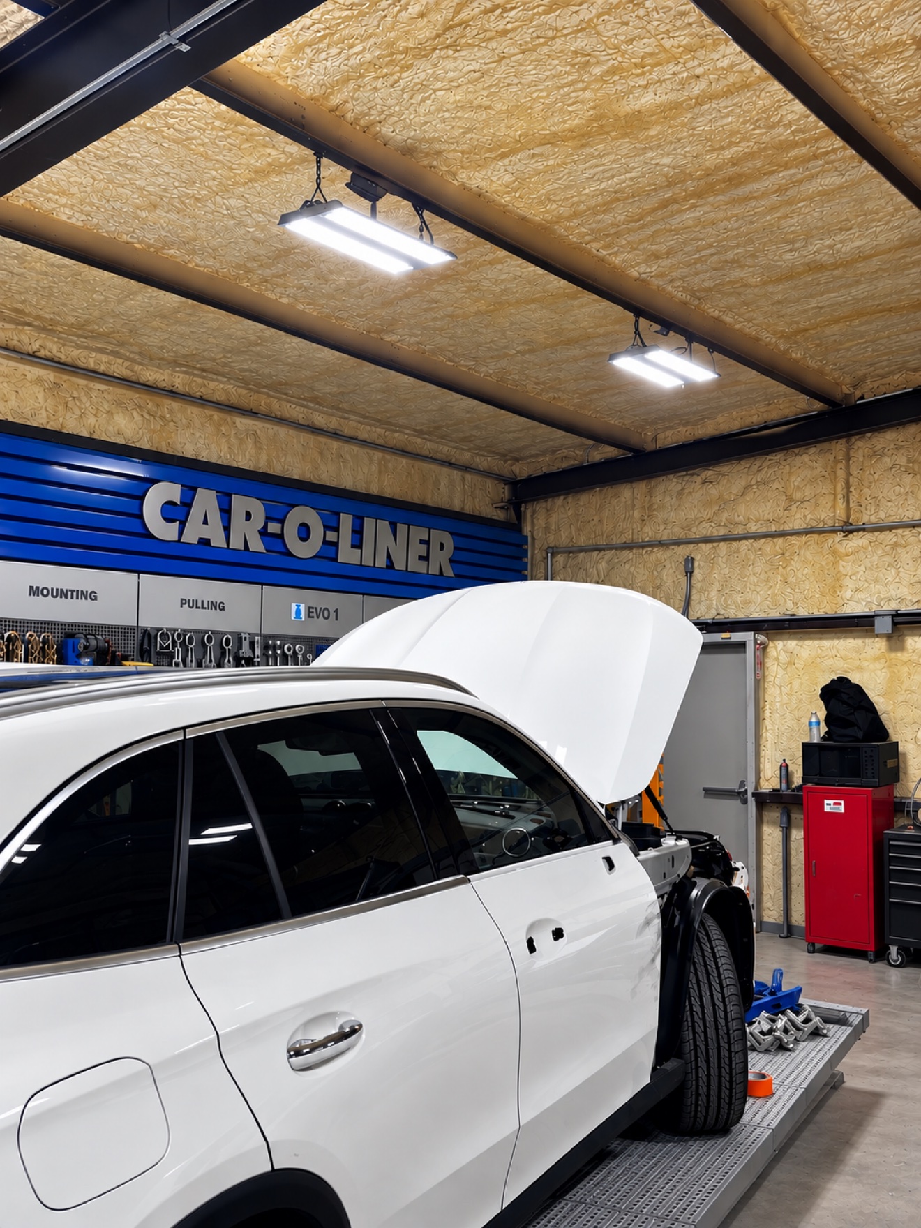 White Mercedes SUV on the Car-O-Liner frame machine at No Limit Auto Body