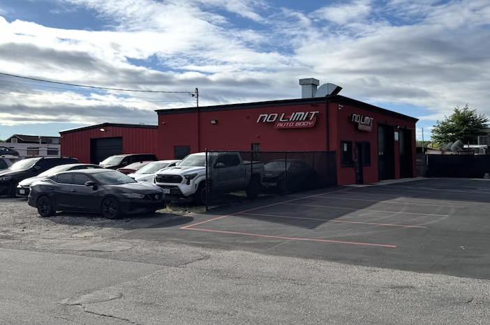 Wide exterior shot of No Limit Auto Body shop in Bay Shore