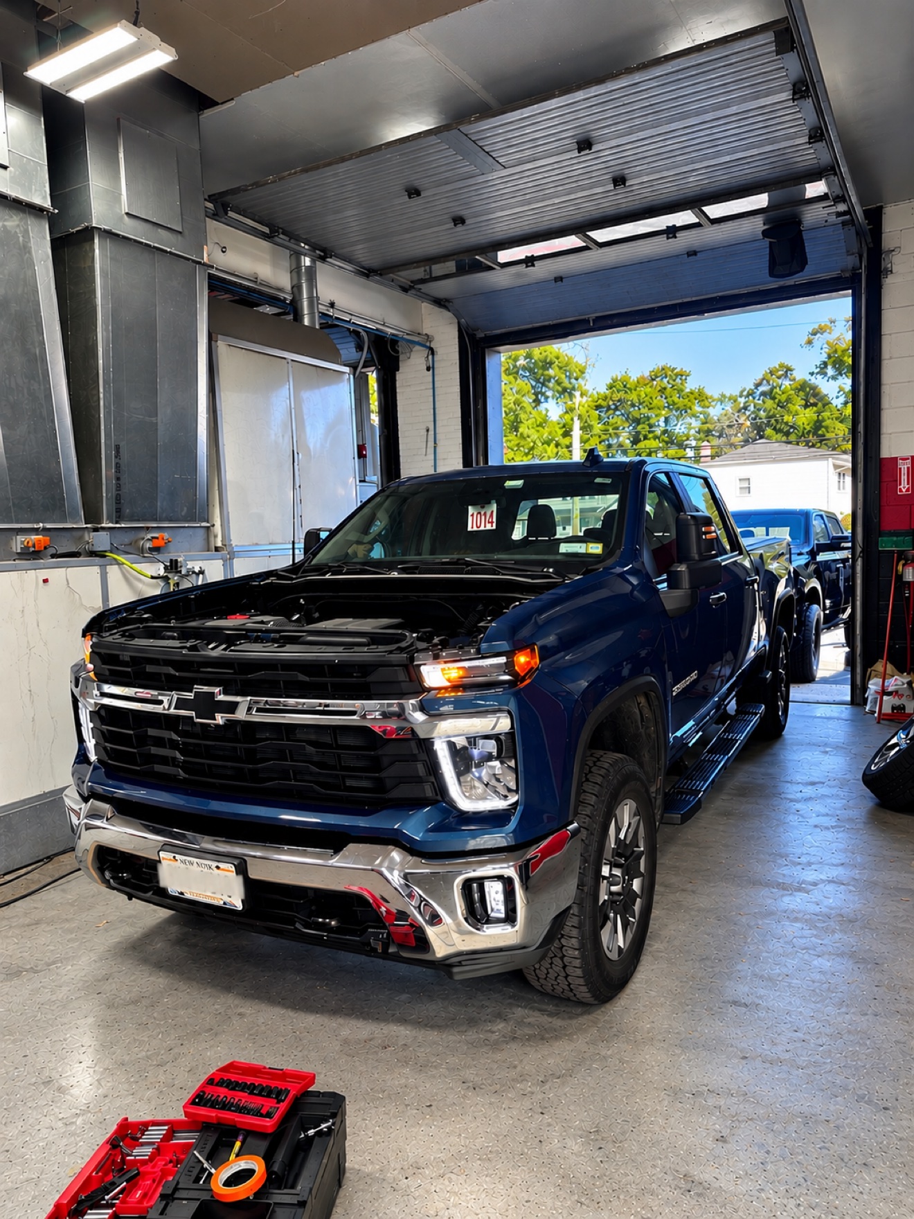 Blue Chevrolet Silverado in a repair bay at No Limit Auto Body