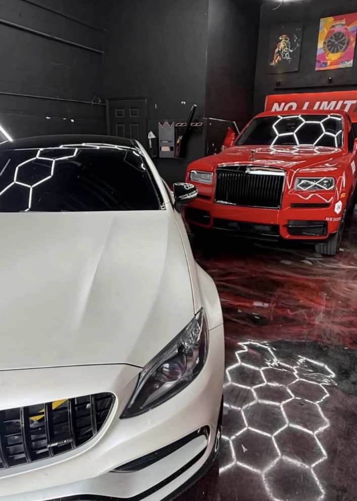 Luxury vehicles inside No Limit Auto Body detailing bay